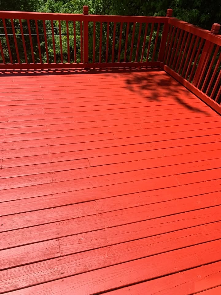 A close-up of a stained deck railing and boards