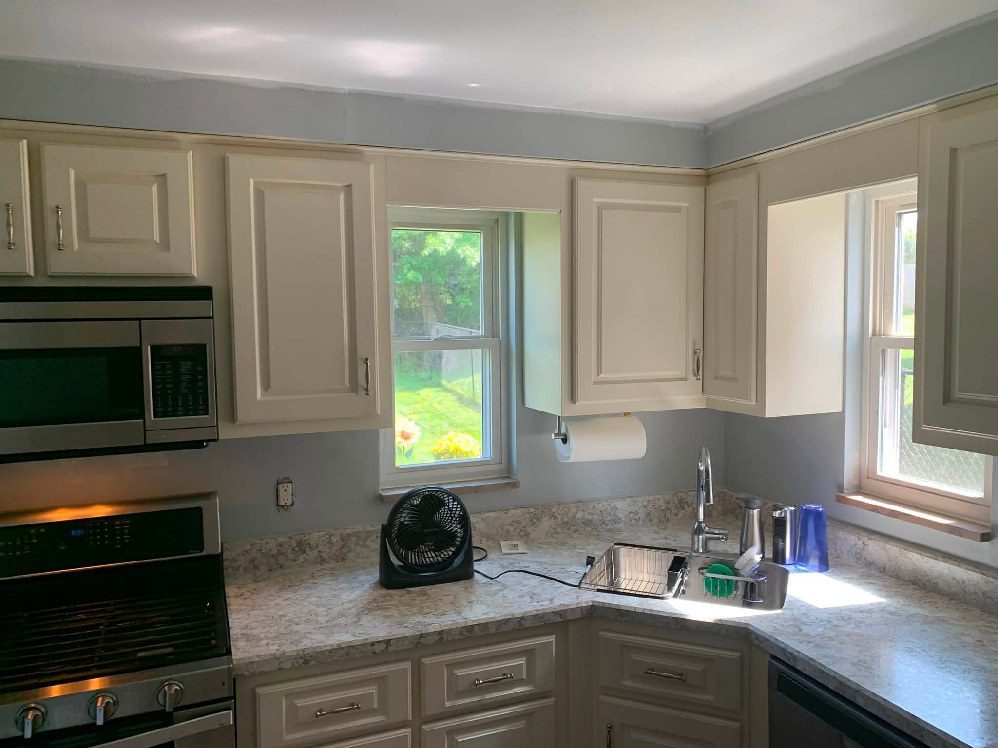 A freshly repainted kitchen in cream tones, completed by D-Rock Painting in the Baldwin area